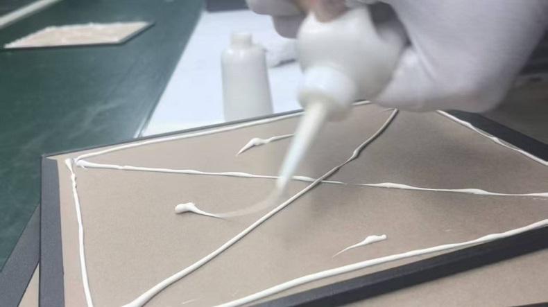 Workers applying glue evenly
