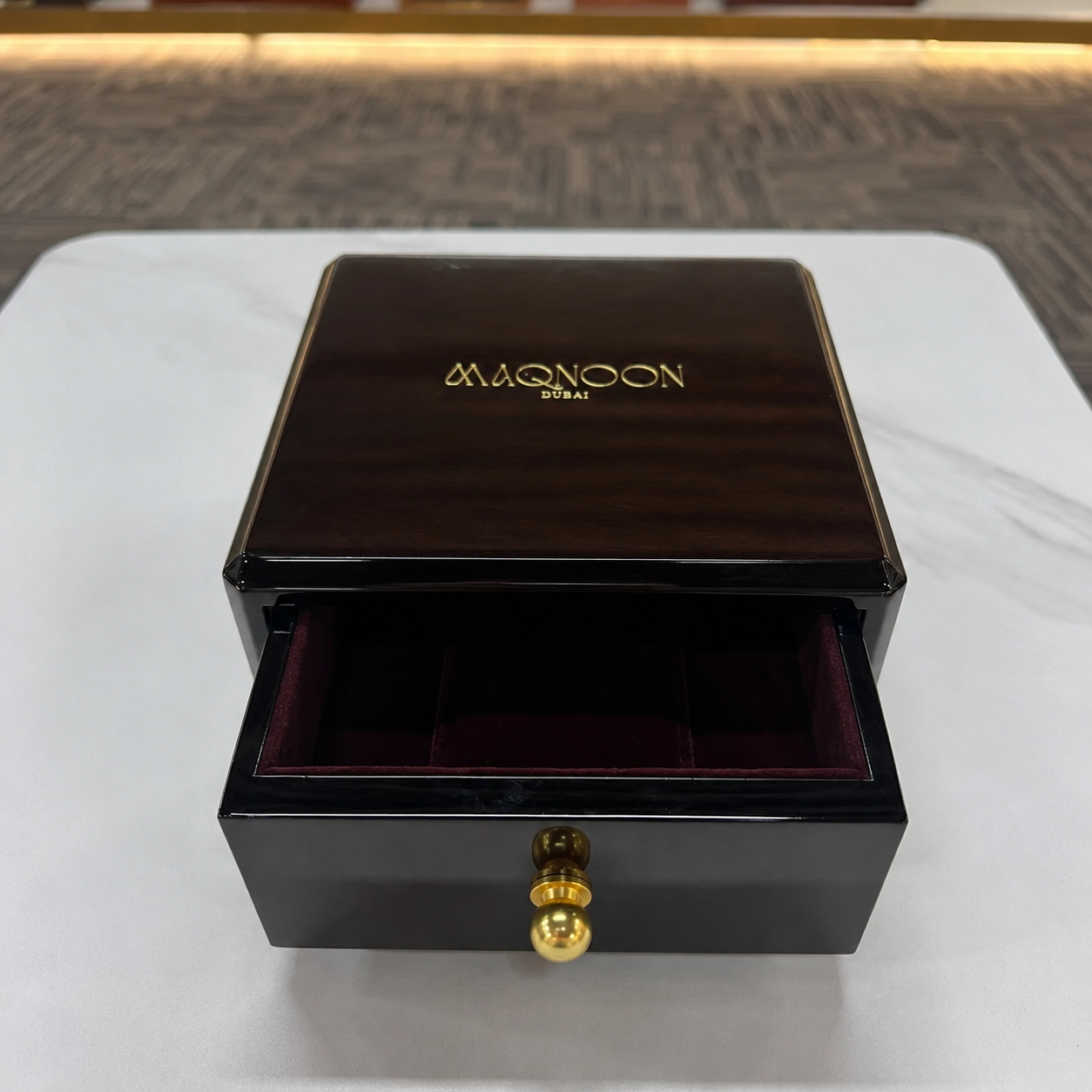 Open wooden watch box displaying watches